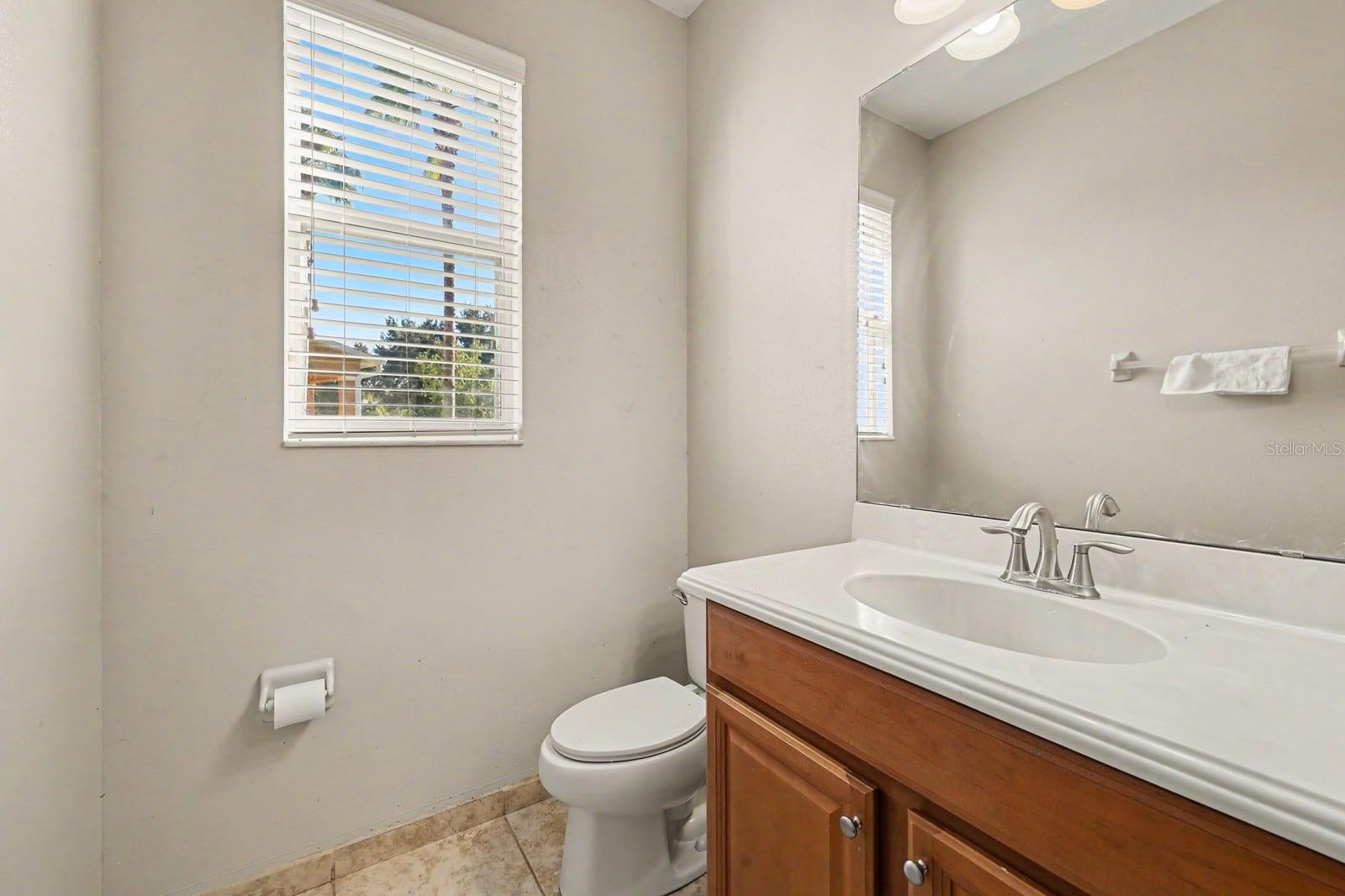 Master Bath Features Wood Vanity, Granite Countertop & Window Light