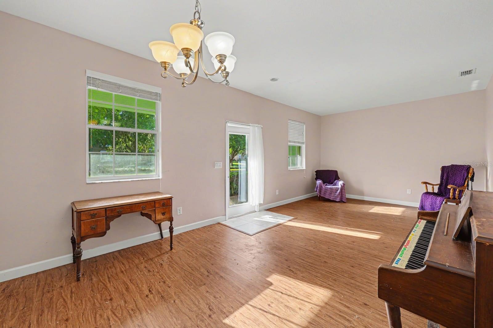 Spacious room with hardwood floors and abundant natural light Spacious room with hardwood floors and abundant natural light