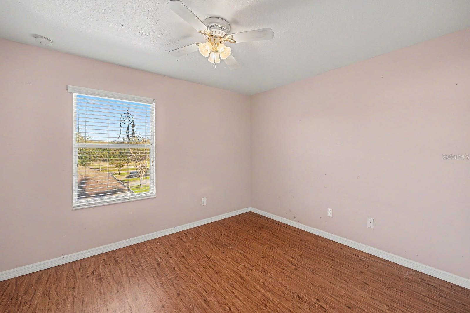Bright Bedroom with Natural Light, Wood Floors & Ample Windows