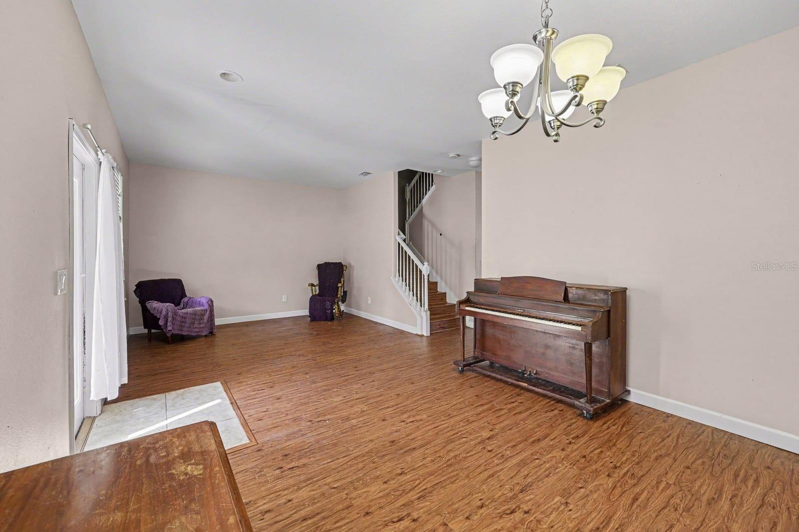 Large bonus room with curved staircase and wood flooring Large bonus room with curved staircase and wood flooring