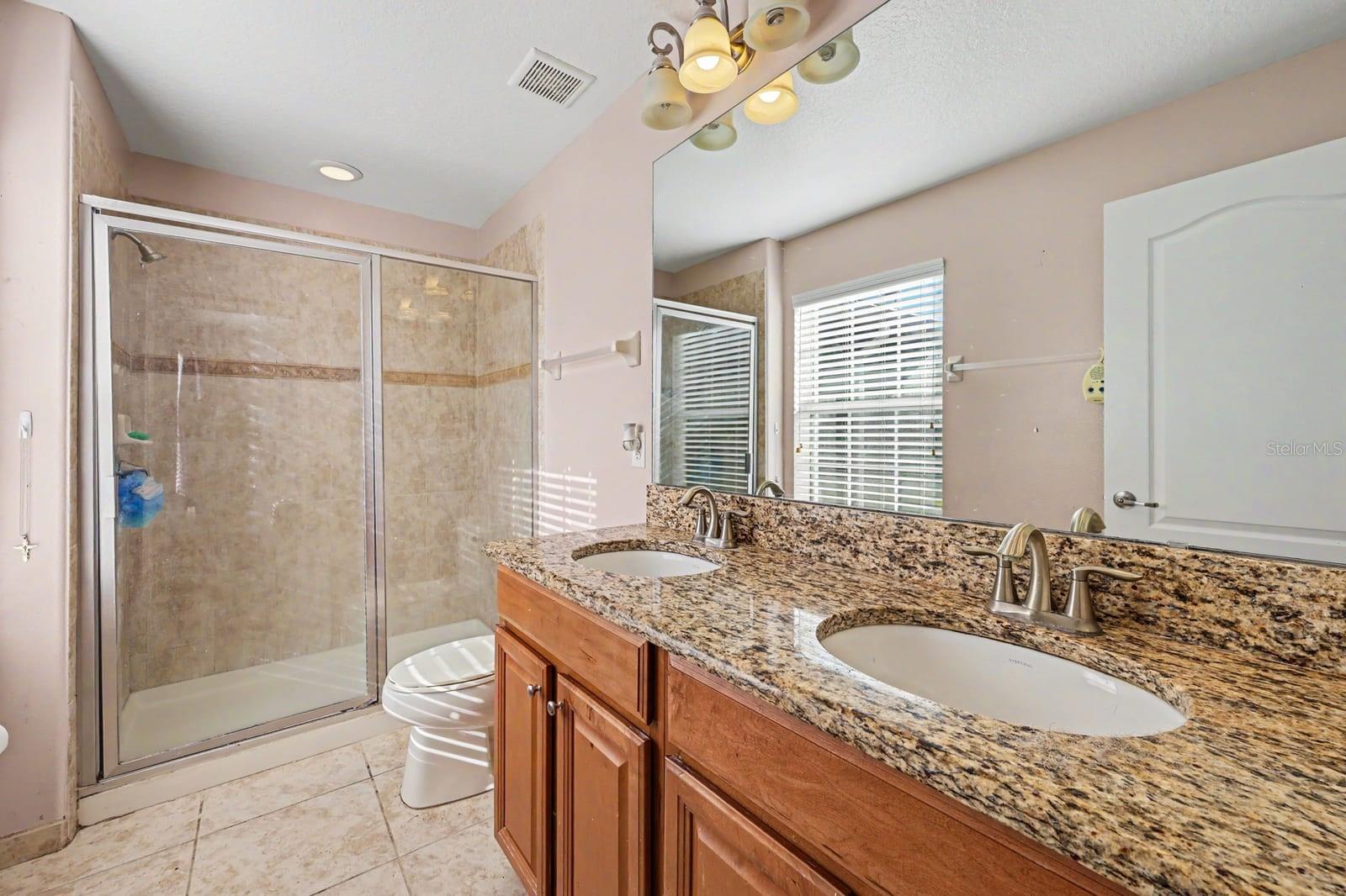 Spa-like Master Bath with Dual Vanities, Granite Countertops & Spacious Walk-In Shower
