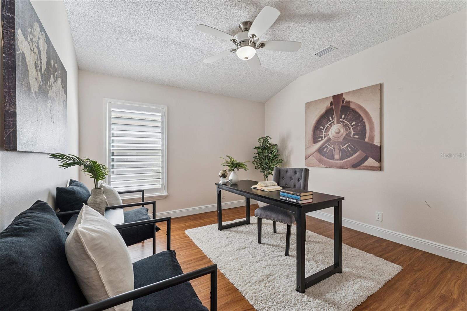 11'6" x 12' Bedroom #3 w/ Plantation style shutters & a ceiling fan