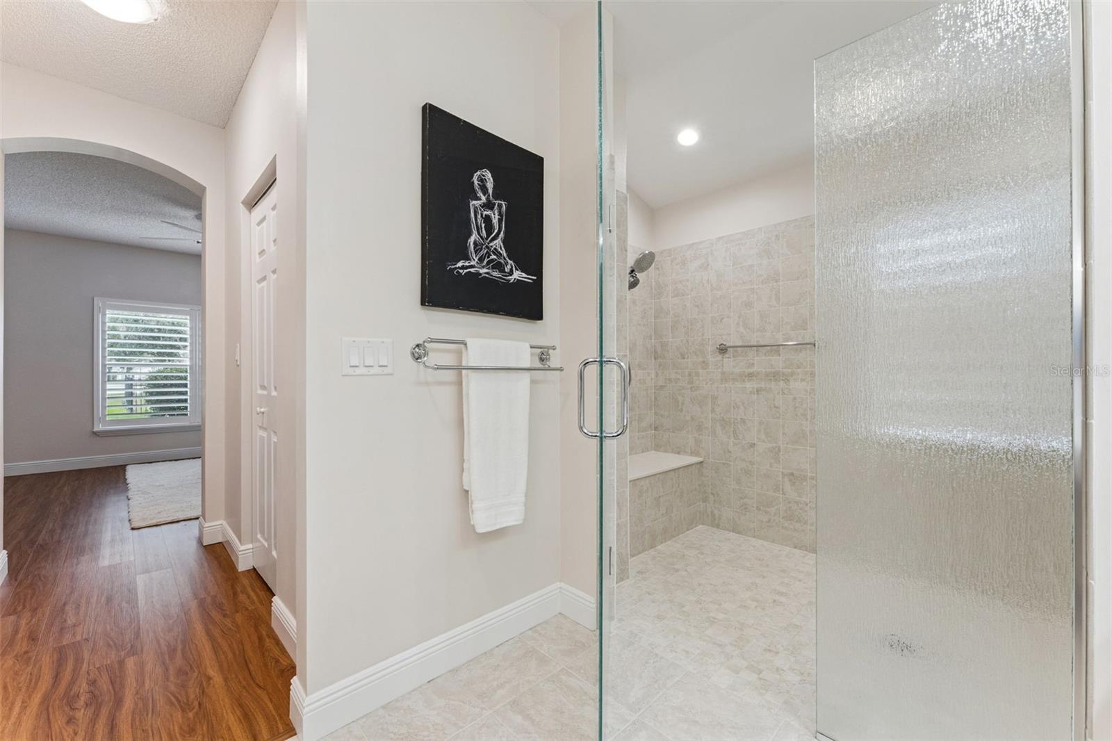 Primary Bathroom walk-in shower w/ bench seat