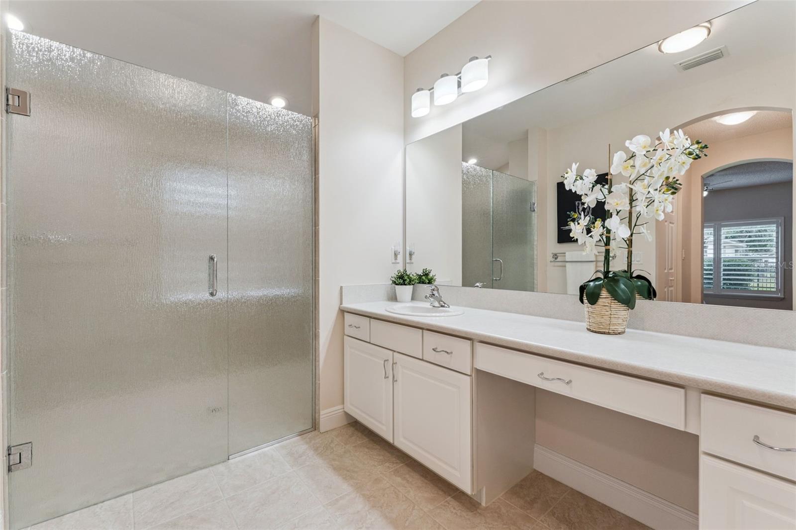 Primary Bathroom w/ a large frameless glass enclosured walk-in shower