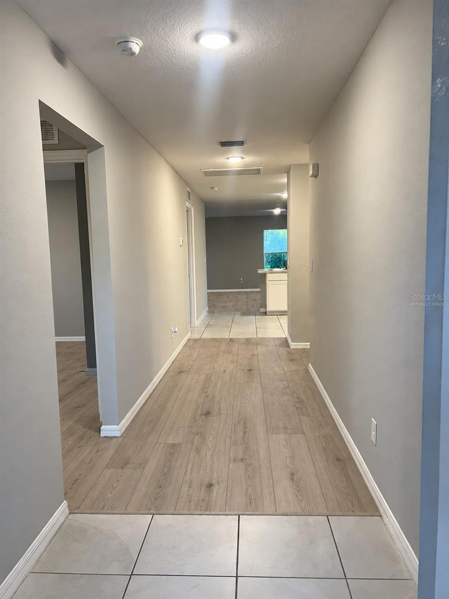 Entry hallway virtually staged: planned laminate flooring where shown. Entry hallway virtually staged: planned laminate flooring where shown.