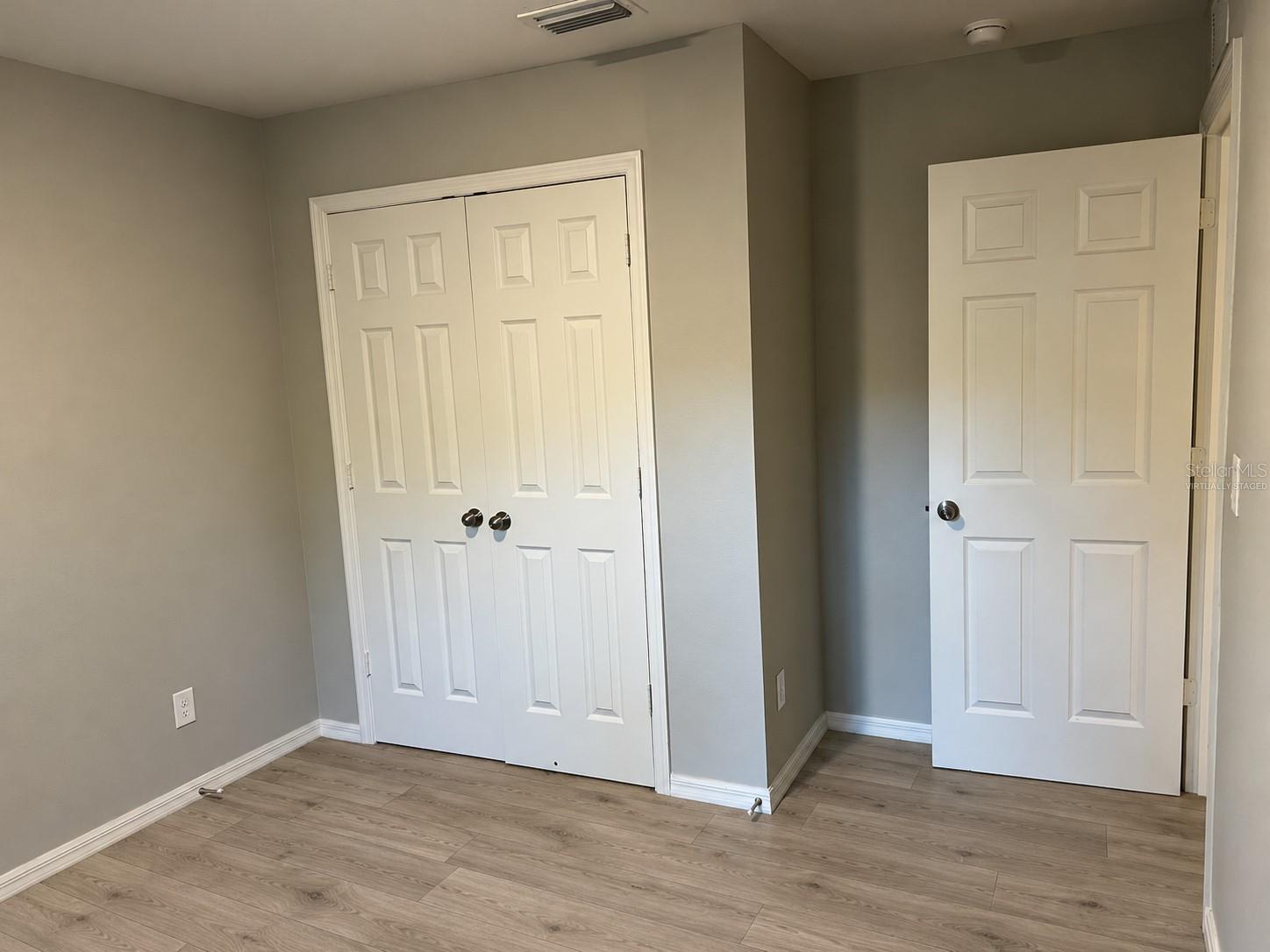 Bedroom 1 closet  virtually staged: planned laminate flooring.