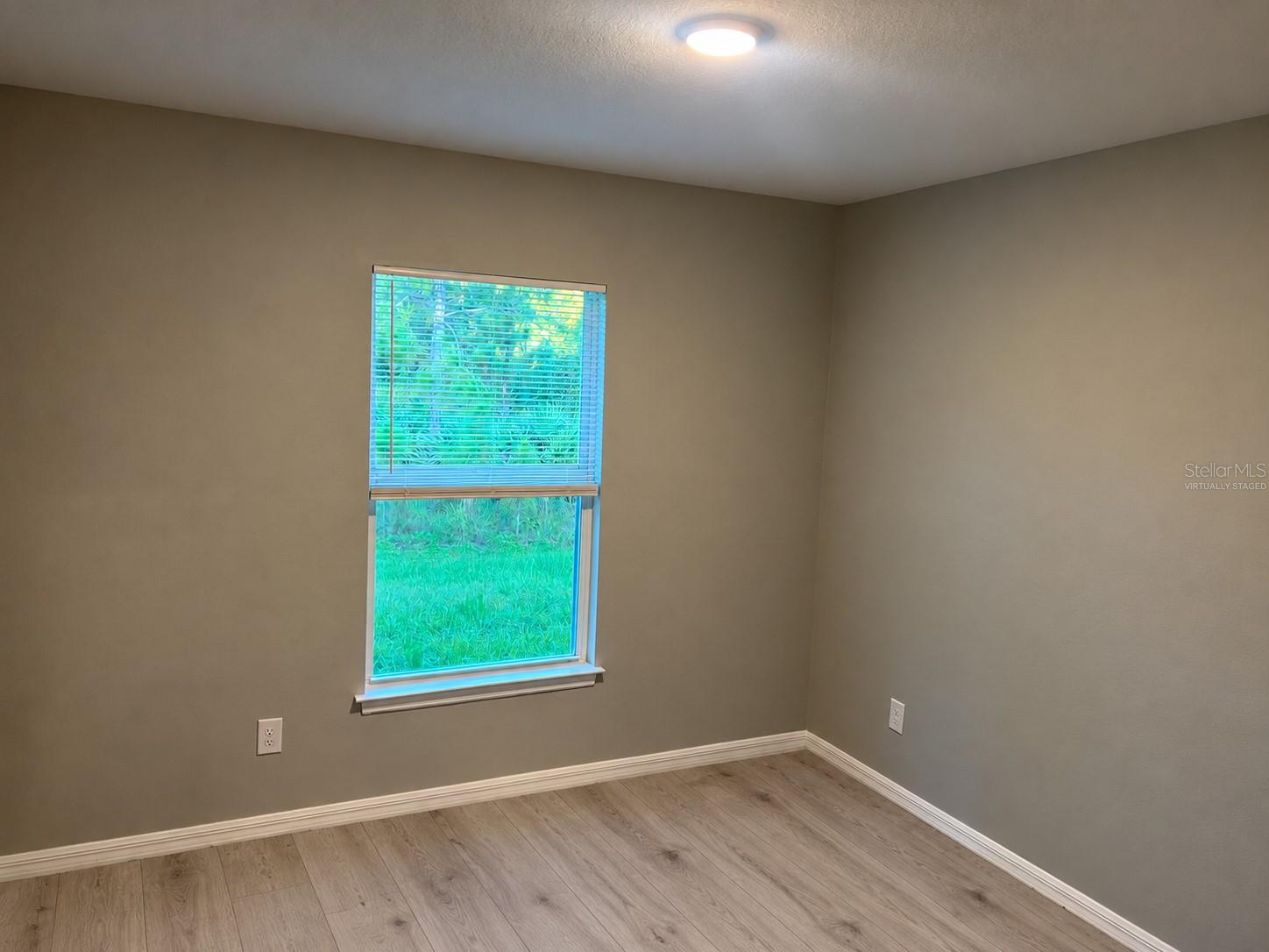 Bedroom 3  virtually staged: planned laminate flooring.