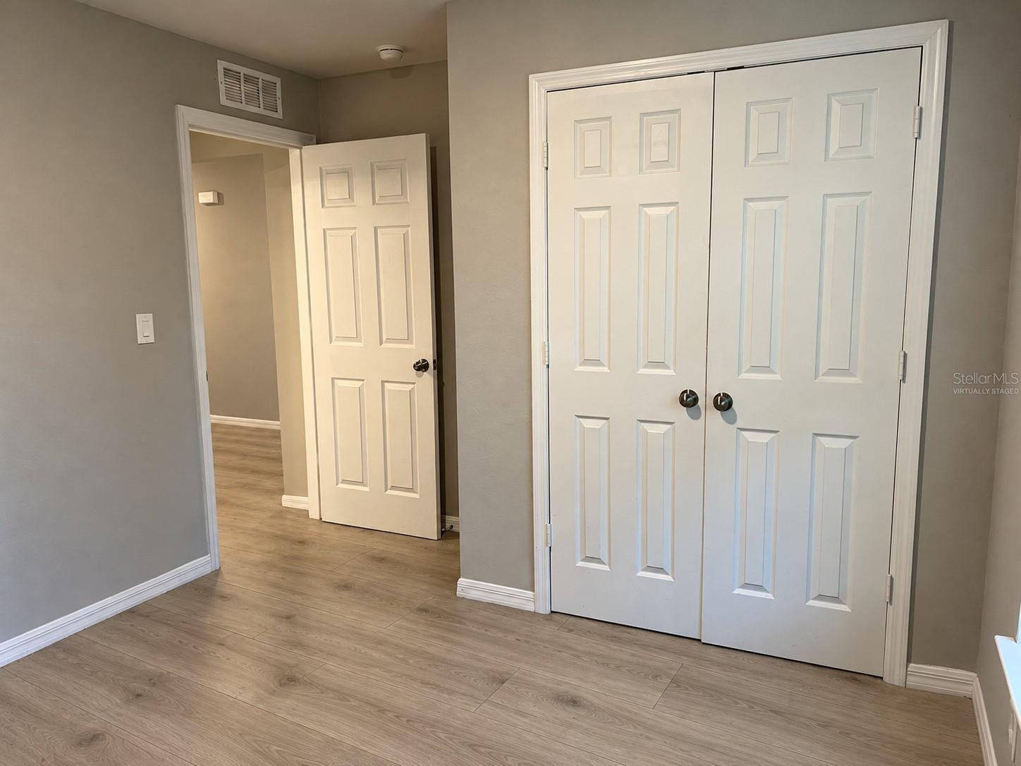 Bedroom 2 closet  virtually staged: planned laminate flooring.