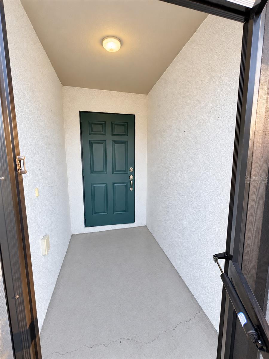 Covered entry virtually staged: proposed concrete-gray porch finish. Covered entry virtually staged: proposed concrete-gray porch finish.