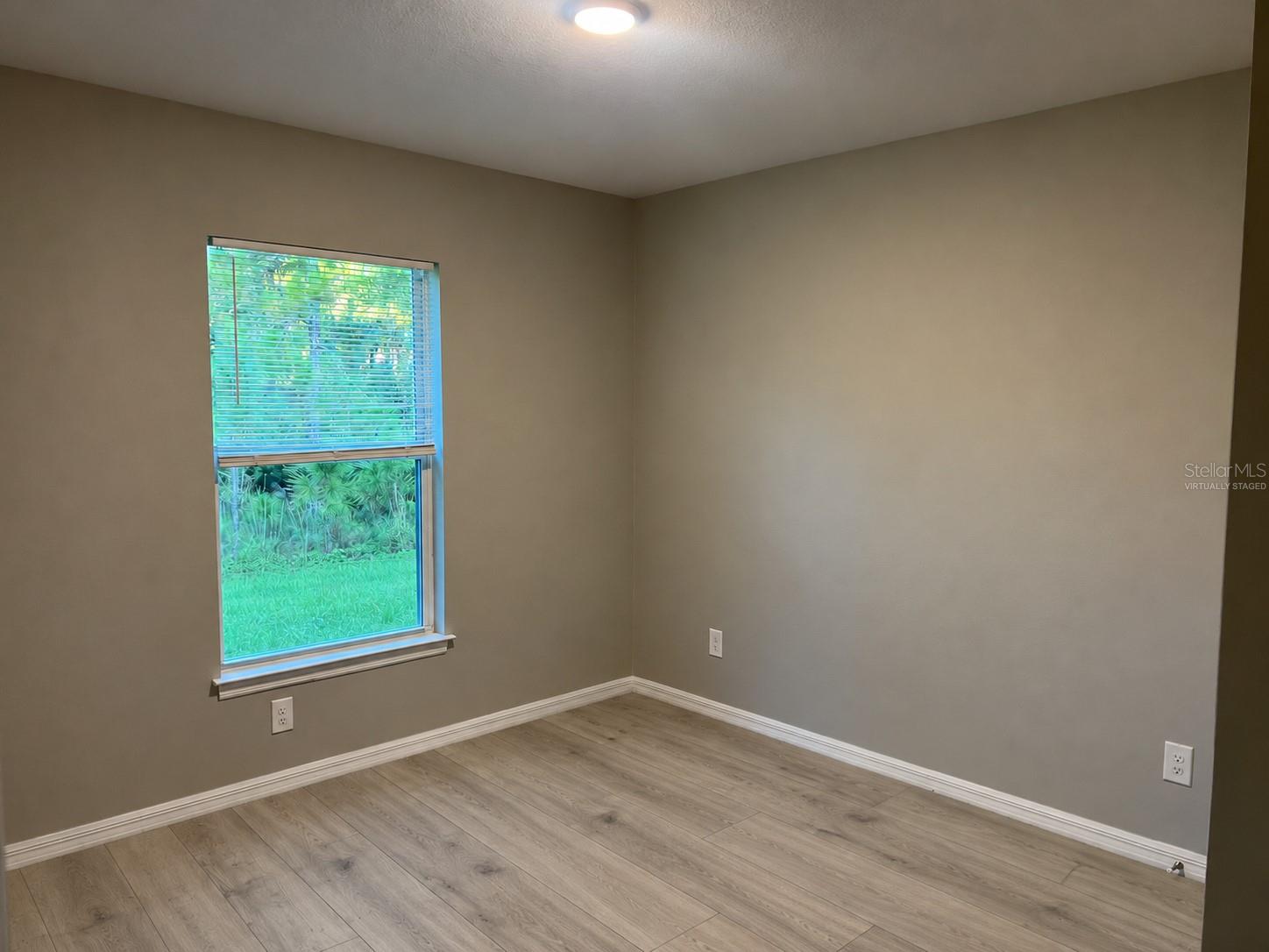 Bedroom 1  virtually staged: planned laminate flooring.