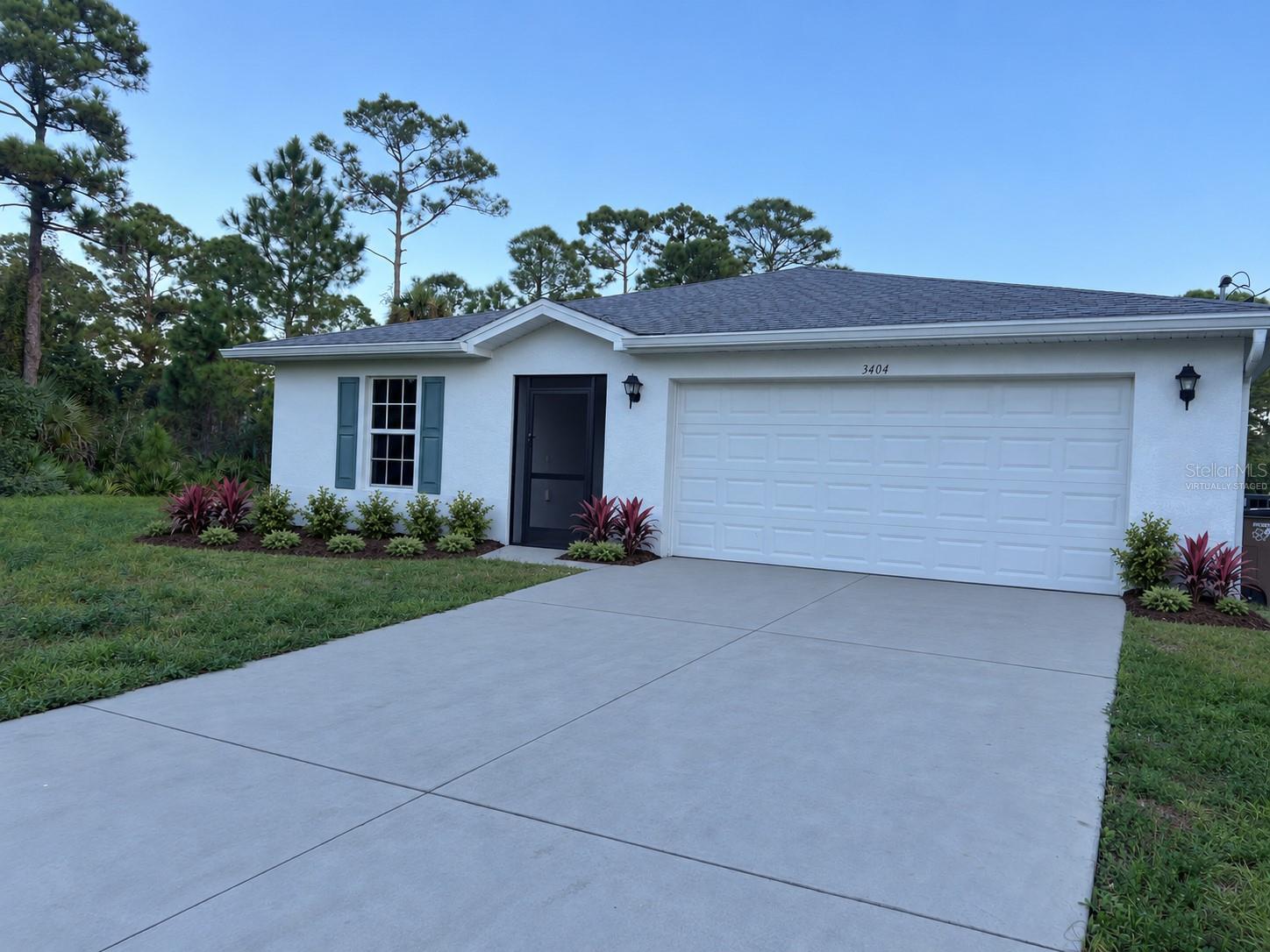 Front exterior virtually staged: proposed landscaping and concrete-gray driveway finish. Front exterior virtually staged: proposed landscaping and concrete-gray driveway finish.