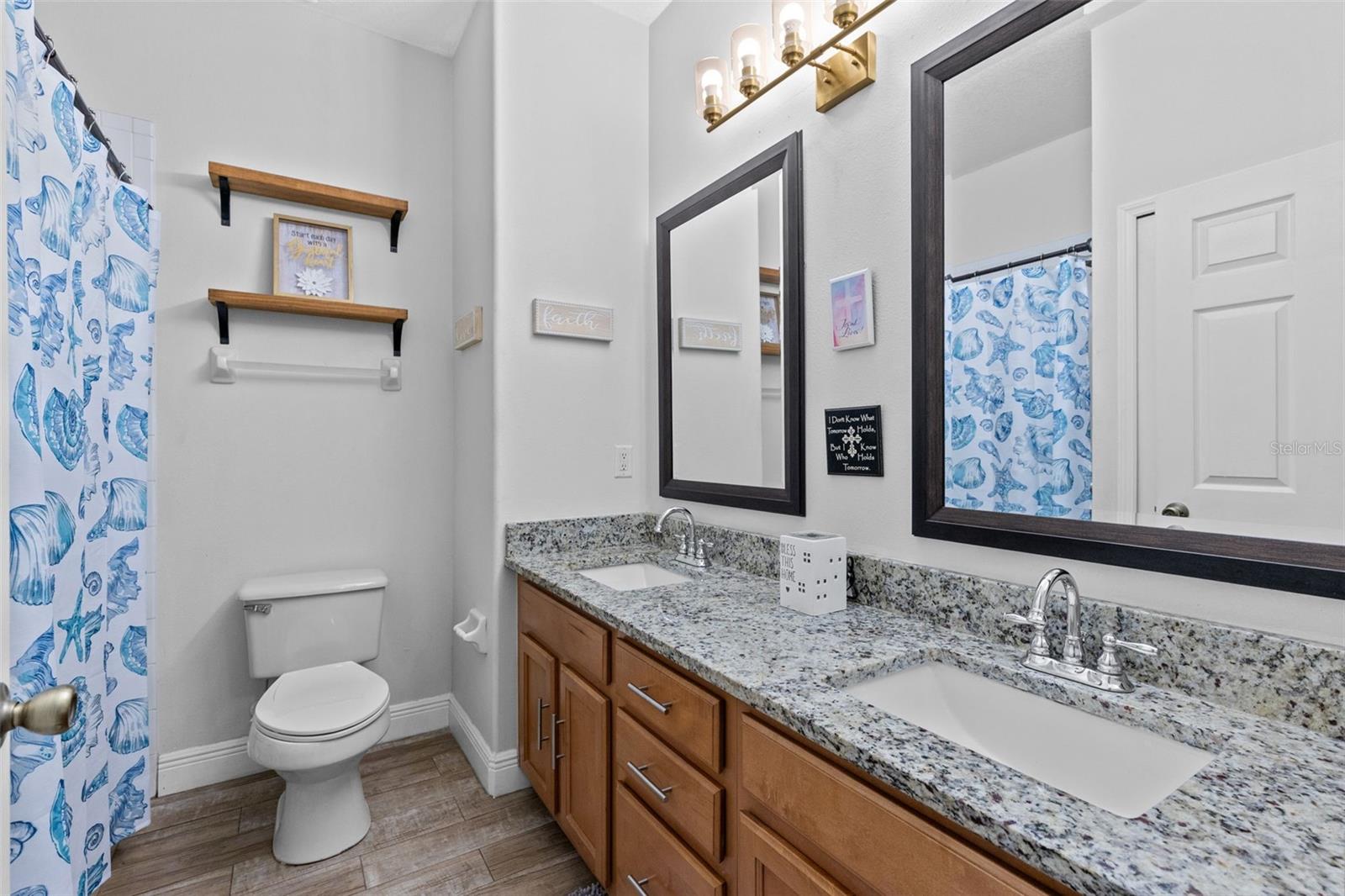 2nd bathroom with double vanity and shower with tub