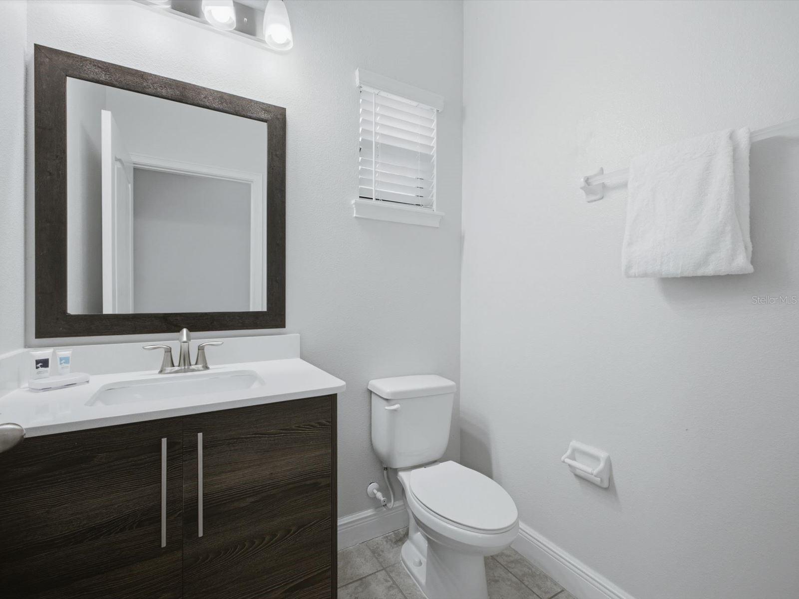 Half bath connected to pool deck and kitchen