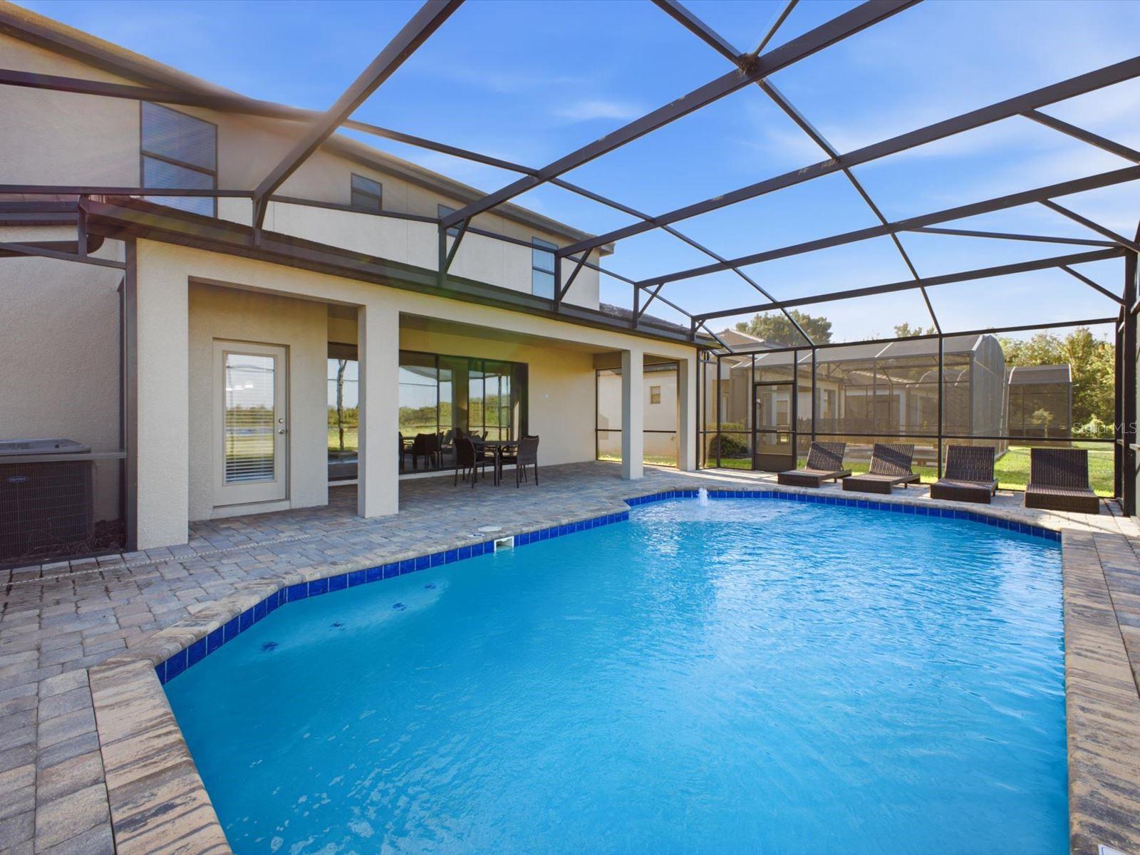 Screened in pool with water view and covered patio Screened in pool with water view and covered patio