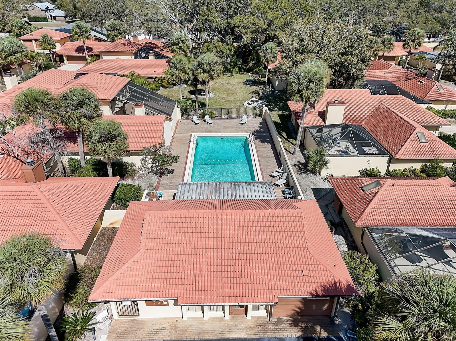 The Island Club HOA covers professionally maintained landscaping and grounds, roof maintenance, exterior painting, and access to the community clubhouse, fitness center, and Olympic-size community swimming pool. Community-wide exterior painting is planned for 2027.