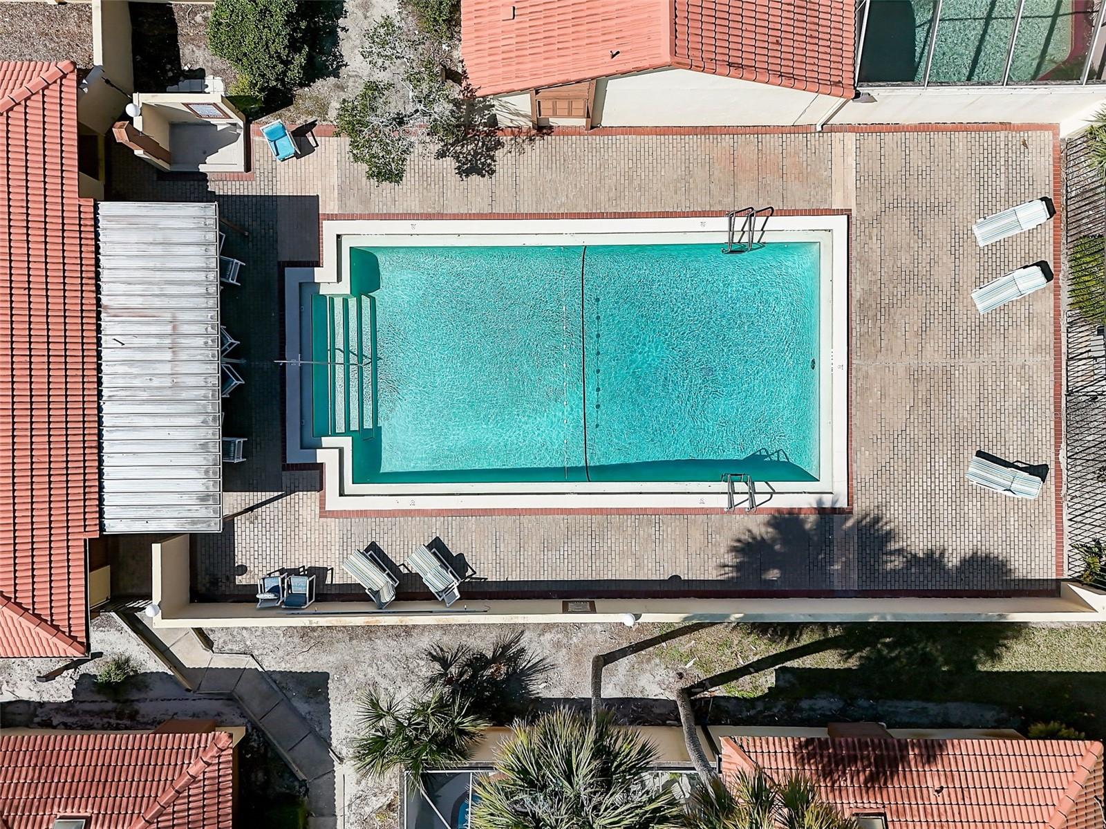 The Island Club HOA covers professionally maintained landscaping and grounds, roof maintenance, exterior painting, and access to the community clubhouse, fitness center, and Olympic-size community swimming pool. Community-wide exterior painting is planned for 2027.