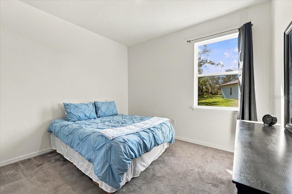 Bright and inviting secondary bedroom featuring natural light, comfortable living space, and a versatile layout. Bright and inviting secondary bedroom featuring natural light, comfortable living space, and a versatile layout.