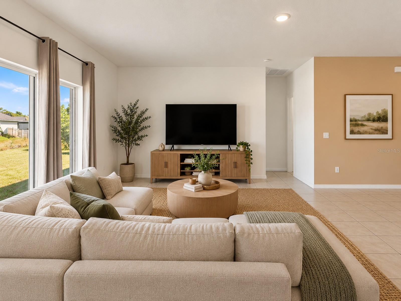 Digitally staged living room showcasing a spacious layout, abundant natural light, and sliding glass door access to the backyard. Digitally staged living room showcasing a spacious layout, abundant natural light, and sliding glass door access to the backyard.