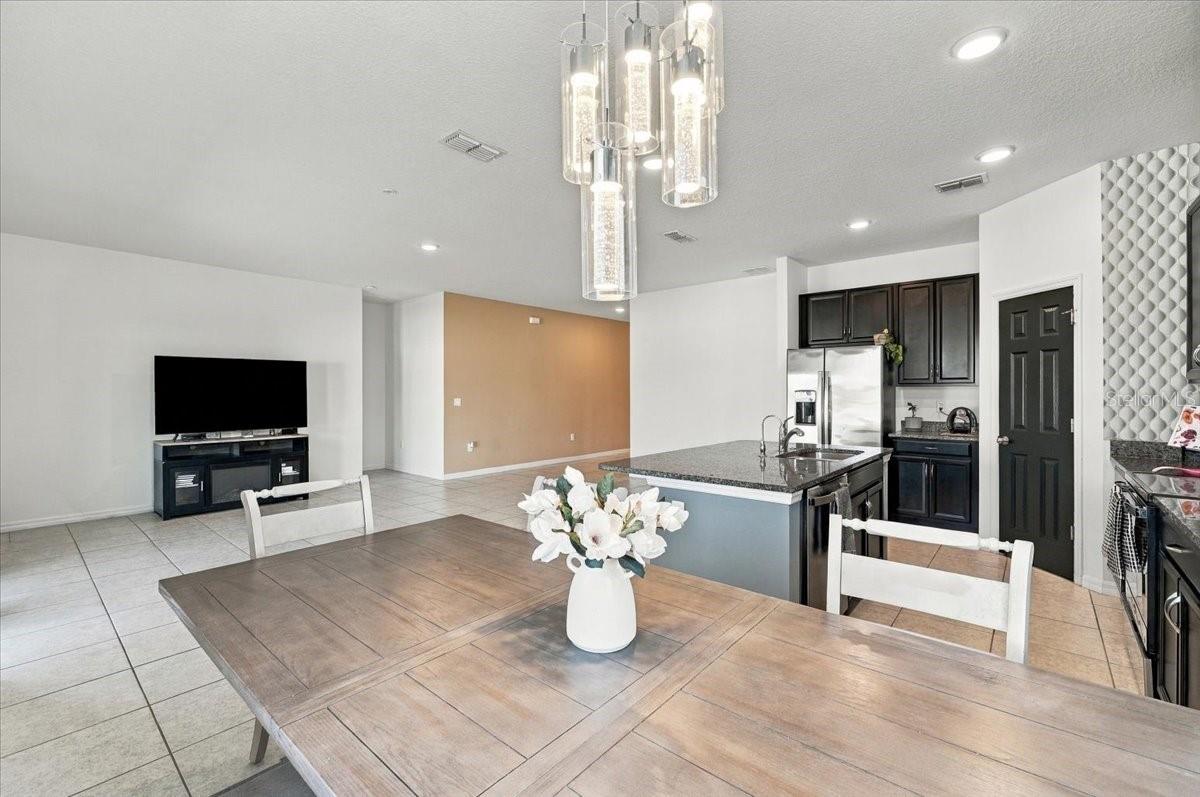 Open-concept kitchen and dining area with plenty of natural light and an inviting layout for everyday living and entertaining. Open-concept kitchen and dining area with plenty of natural light and an inviting layout for everyday living and entertaining.