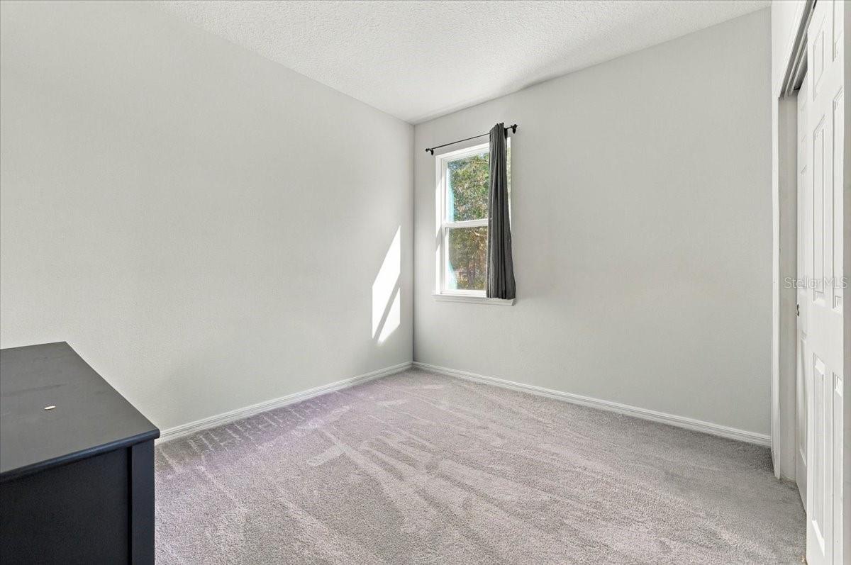 Versatile fourth bedroom, ideal for a guest room, home office, or additional living space.