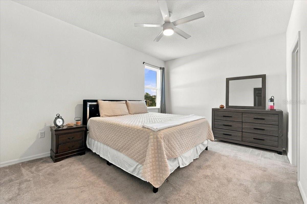 Spacious primary bedroom with room for a king-size bed and additional bedroom furniture. Spacious primary bedroom with room for a king-size bed and additional bedroom furniture.