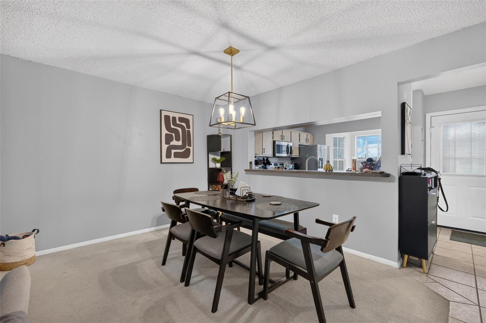 Dining space with opening to kitchen. Dining space with opening to kitchen.