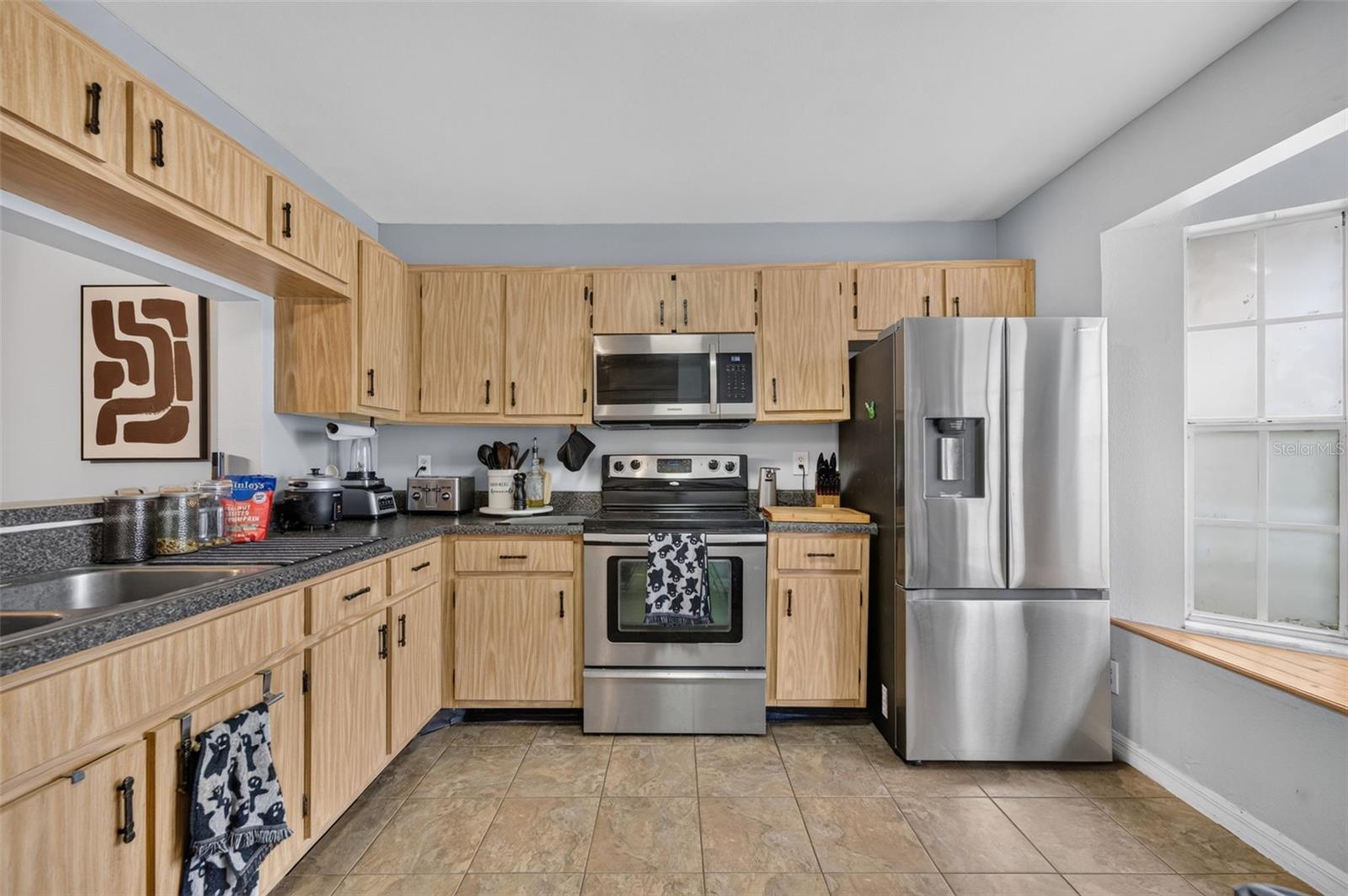 Kitchen is spacious and filled with light from the bay window.