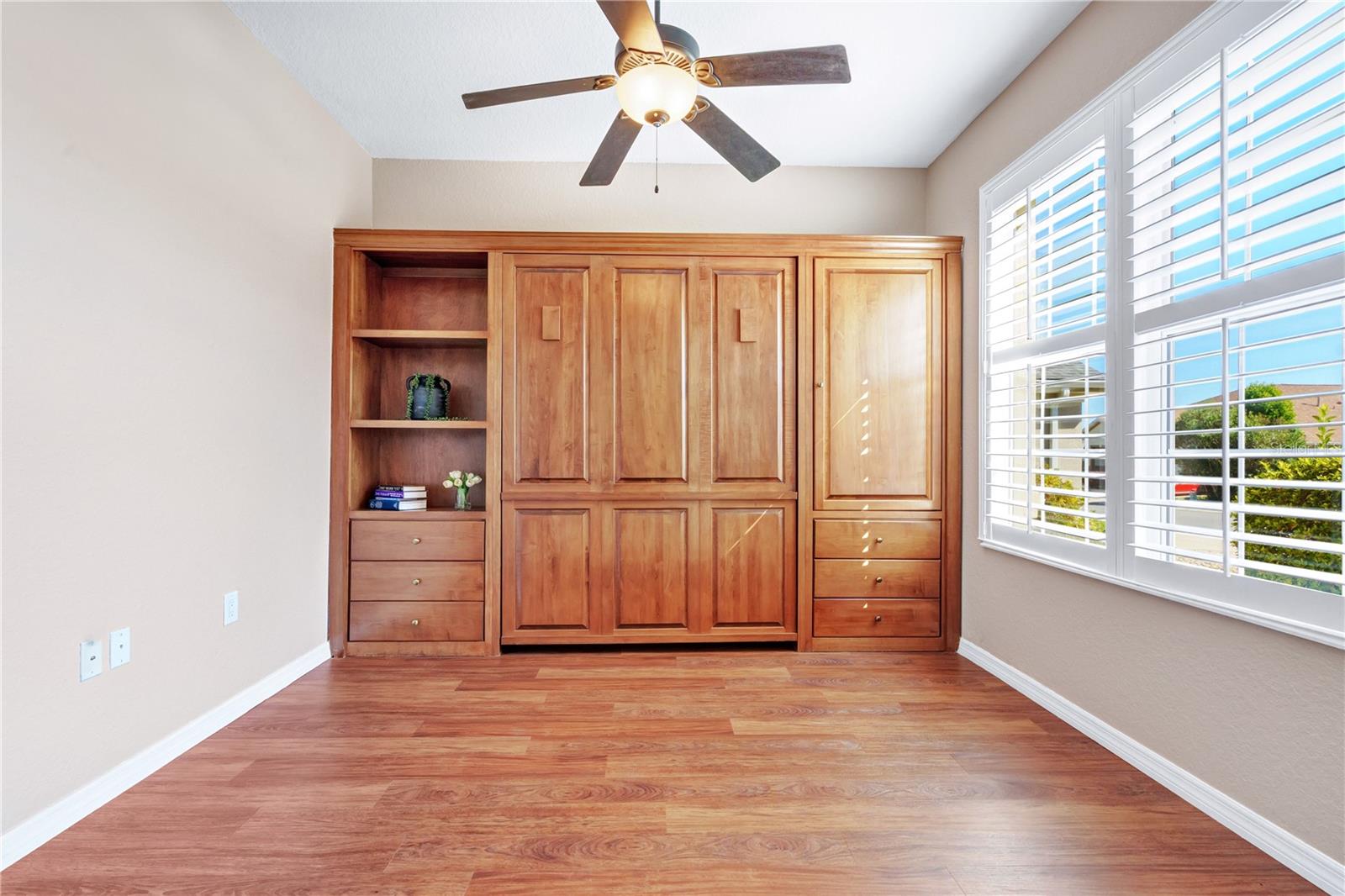 Versatile den with custom cherrywood Murphy bed and built-ins, ideal for an office, hobbies, or overnight guests.