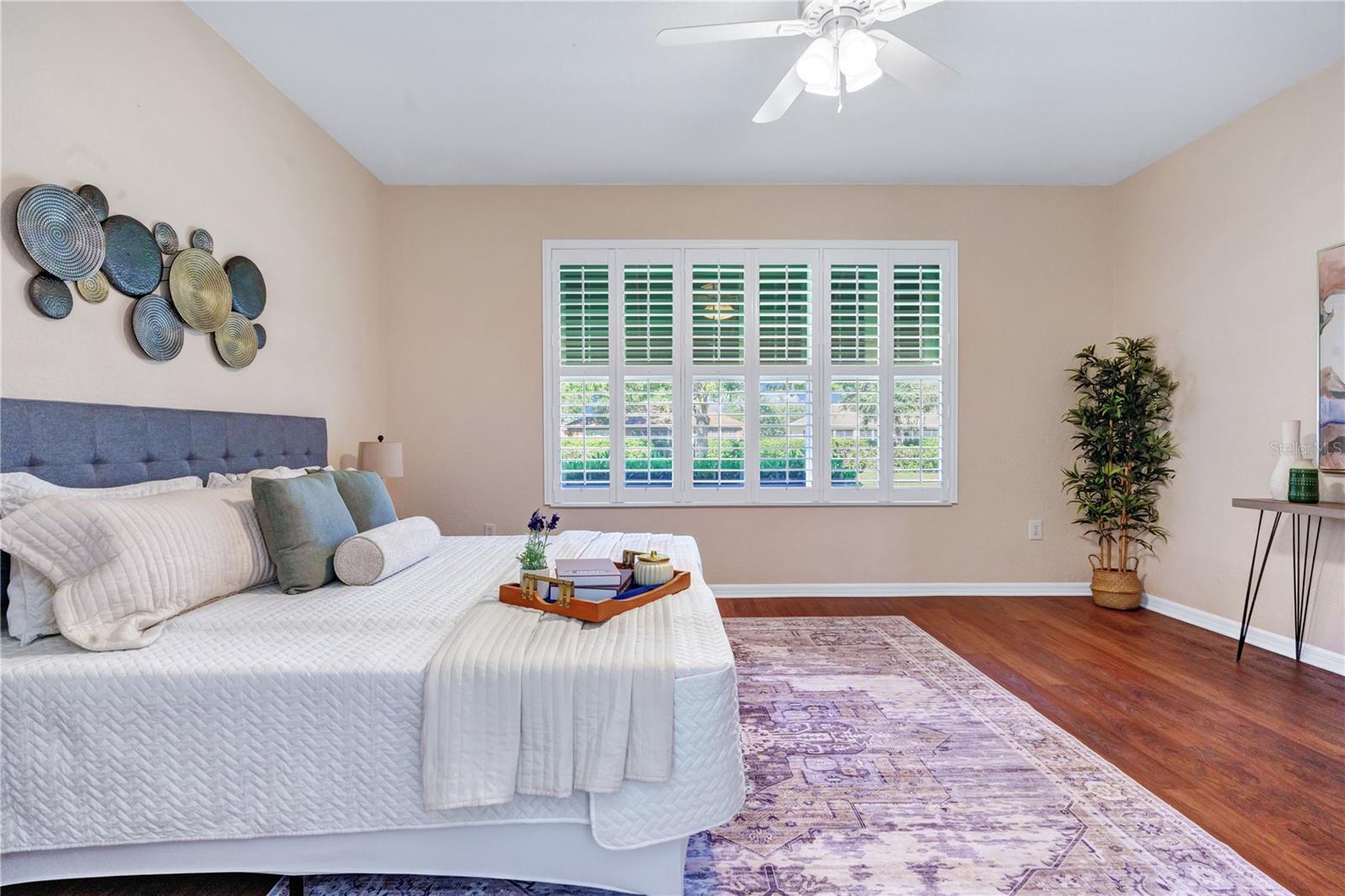 Generously sized primary retreat with large windows and ample space for bedroom furnishings.