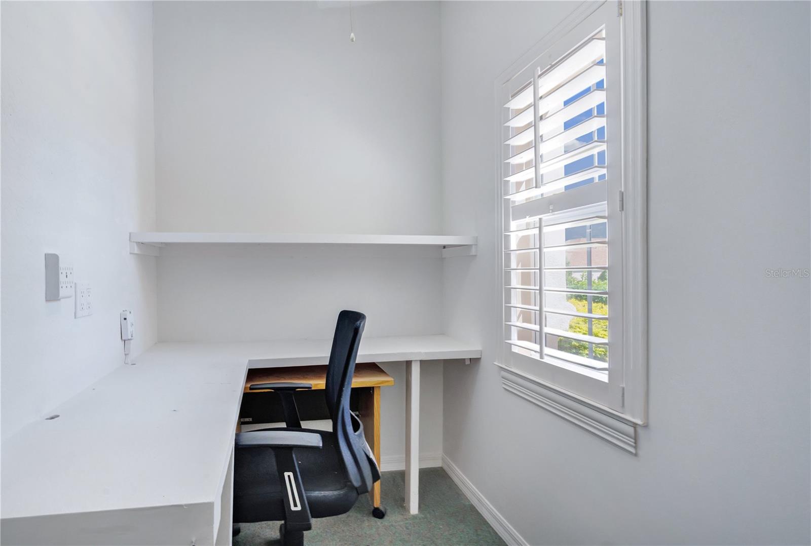 Bonus climate controlled workspace with built-in desk and shelving, ideal for a home office or everyday organization.