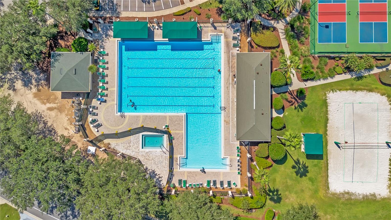 Aerial view of the expansive community swimming pool and nearby recreation