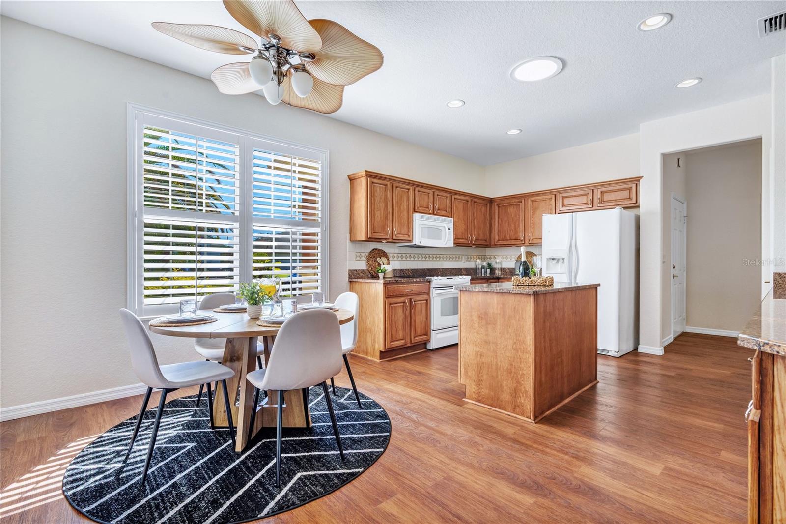 Sunlit breakfast nook overlooking the kitchen, perfect for morning coffee and casual dining.