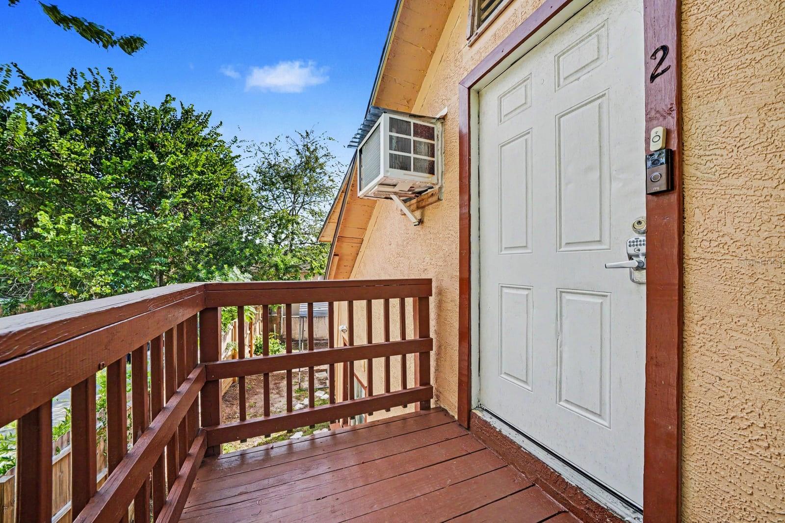 Upper Deck with Wood Railing & Access Door to Home