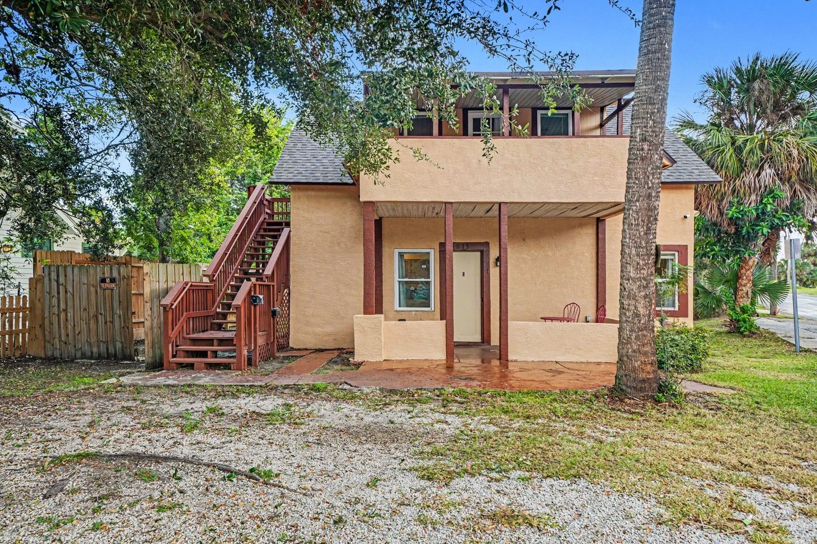 Two-Story Home With Brick Steps, Red Railings & Mature Trees Two-Story Home With Brick Steps, Red Railings & Mature Trees