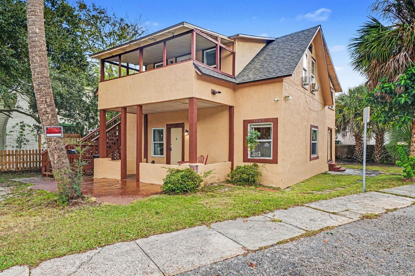 Welcoming Front Facade With Covered Entry & Upper-Level Deck Welcoming Front Facade With Covered Entry & Upper-Level Deck