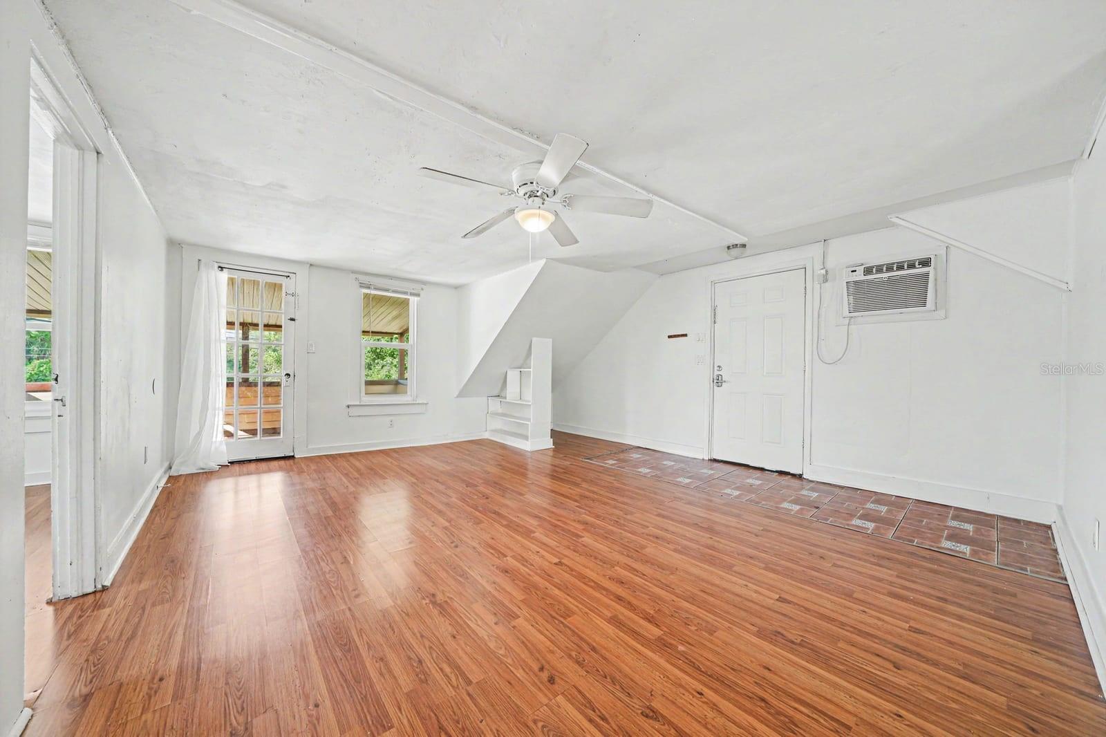 Upper Level Living Space with Wood Floors, Glass Doors & Natural Light