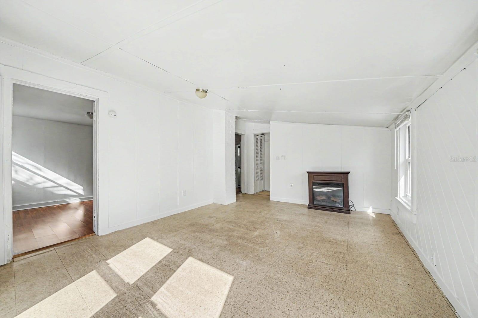 Open Living Area with Fireplace, Tile Flooring & Abundant Sunlight