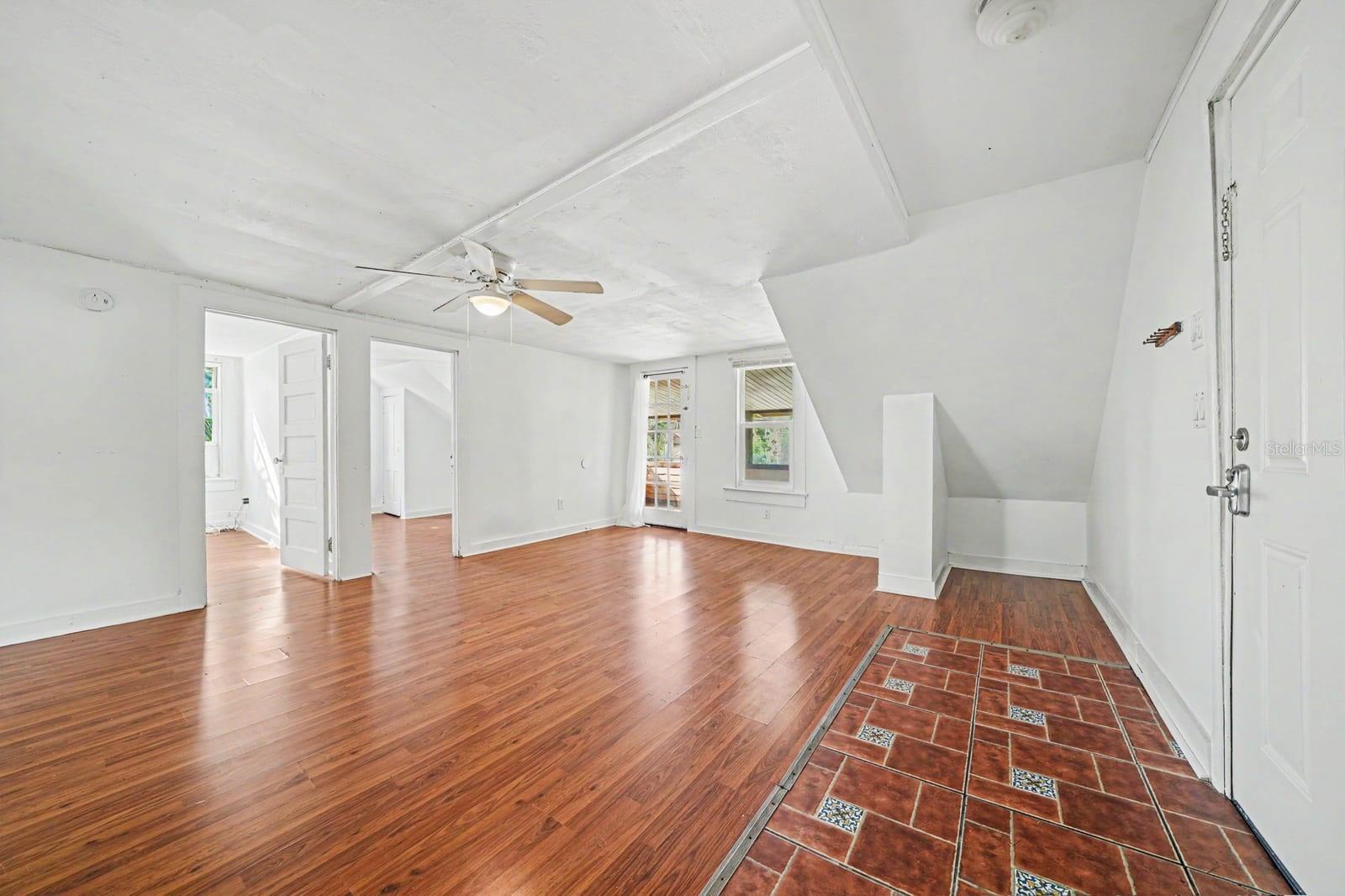 Open Upper Level with Sloped Ceilings, Multiple Doors & Fan