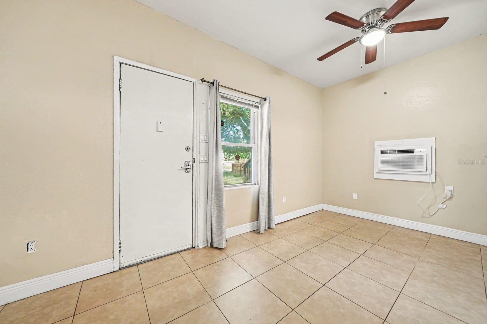 Bright Living Space With Tile Flooring & Ceiling Fan Bright Living Space With Tile Flooring & Ceiling Fan