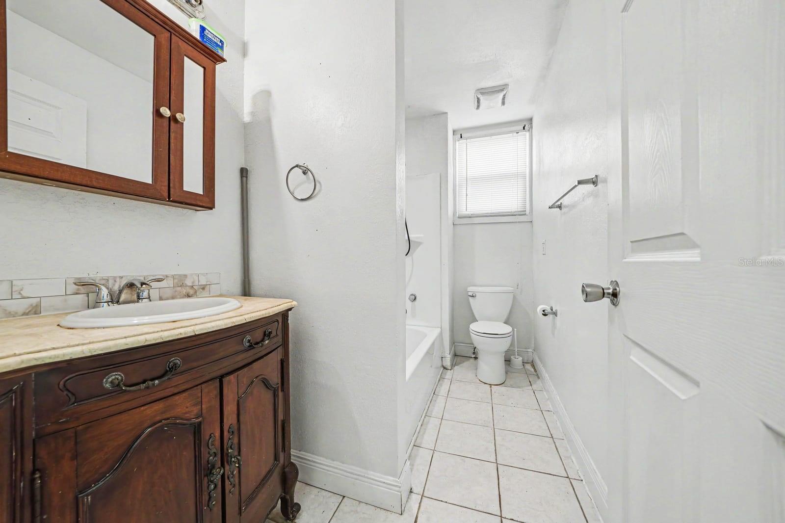 Master Bath with Wood Vanity, Separate Tub & Shower, Tile Flooring