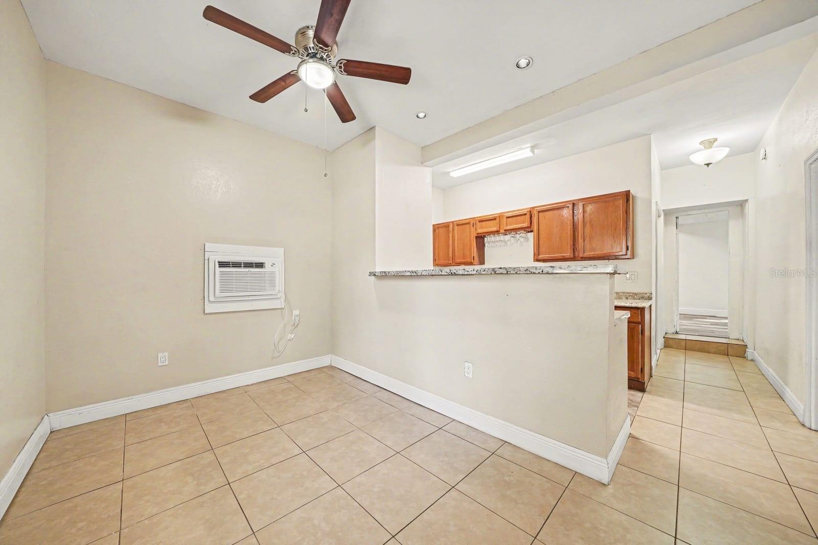 Spacious Dining Area With Kitchen Cabinets & Ceiling Fan Spacious Dining Area With Kitchen Cabinets & Ceiling Fan