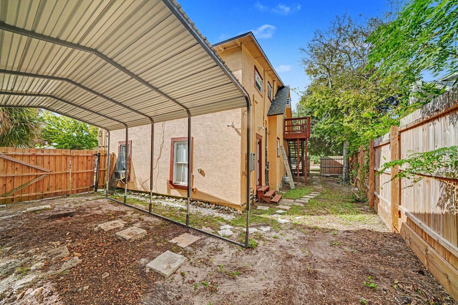 Rear Yard with Carport & Fenced Landscaping Around Home
