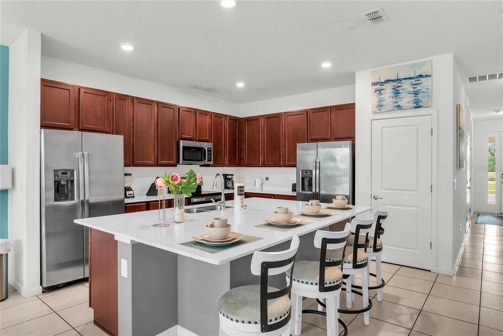 Kitchen with double refrigerator and stainless steel appliances Kitchen with double refrigerator and stainless steel appliances