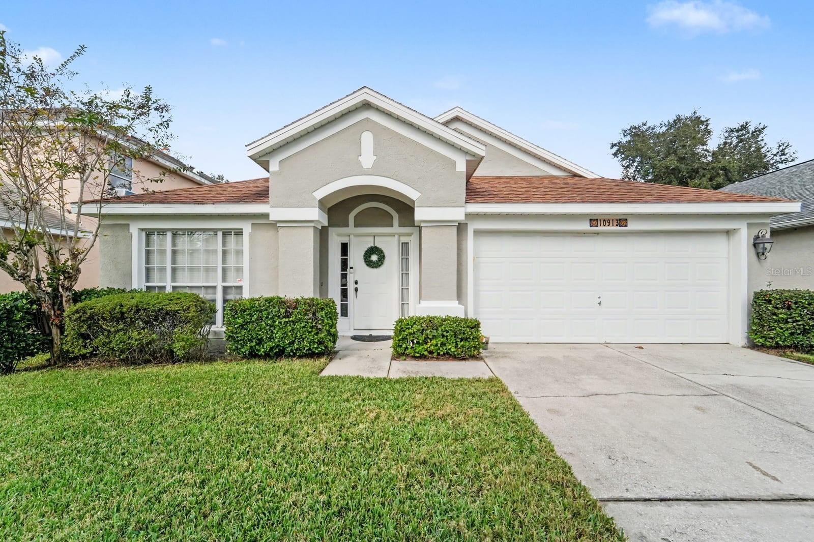 Charming single-story home with clean white exterior and welcoming entry portico Charming single-story home with clean white exterior and welcoming entry portico