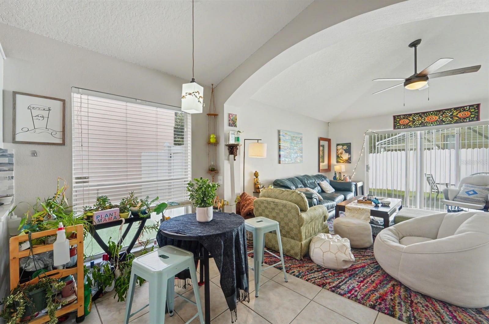 Bright great room with cathedral ceiling, abundant natural light, and multiple seating zones Bright great room with cathedral ceiling, abundant natural light, and multiple seating zones