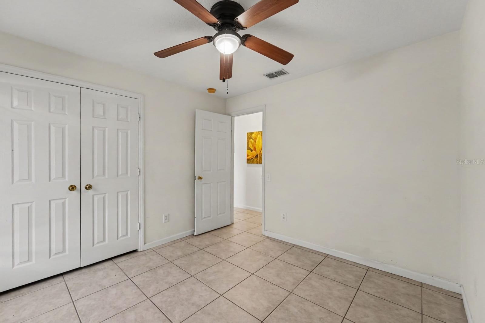 Secondary Bedroom with Double Closets, Tile Floor & Ceiling Fan with Light