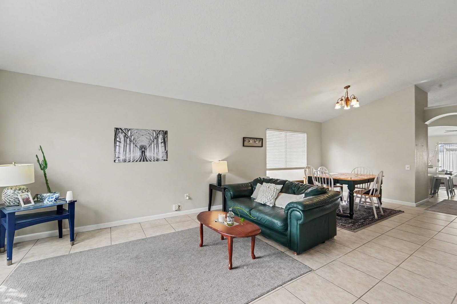 Open Living Areas with Tile Floors, Wood Coffee Table & Abundant Natural Light
