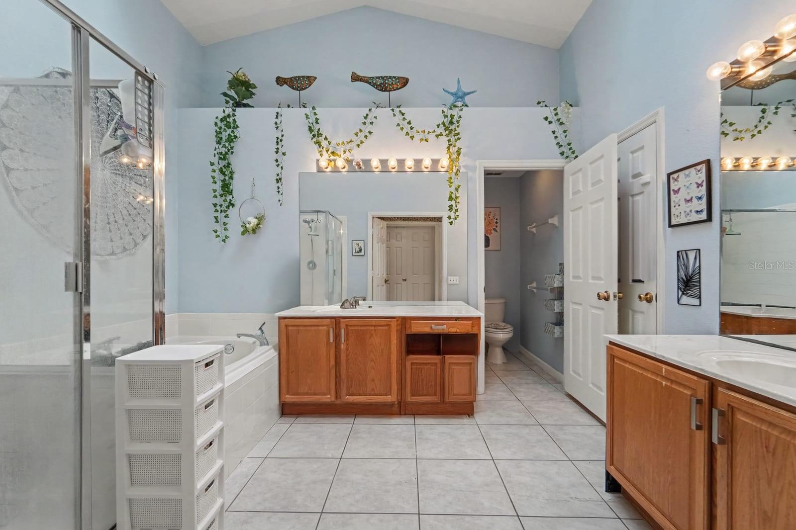 Comfortable Master Bedroom with Ceiling Fan, Large Windows, and Ample Room Layout