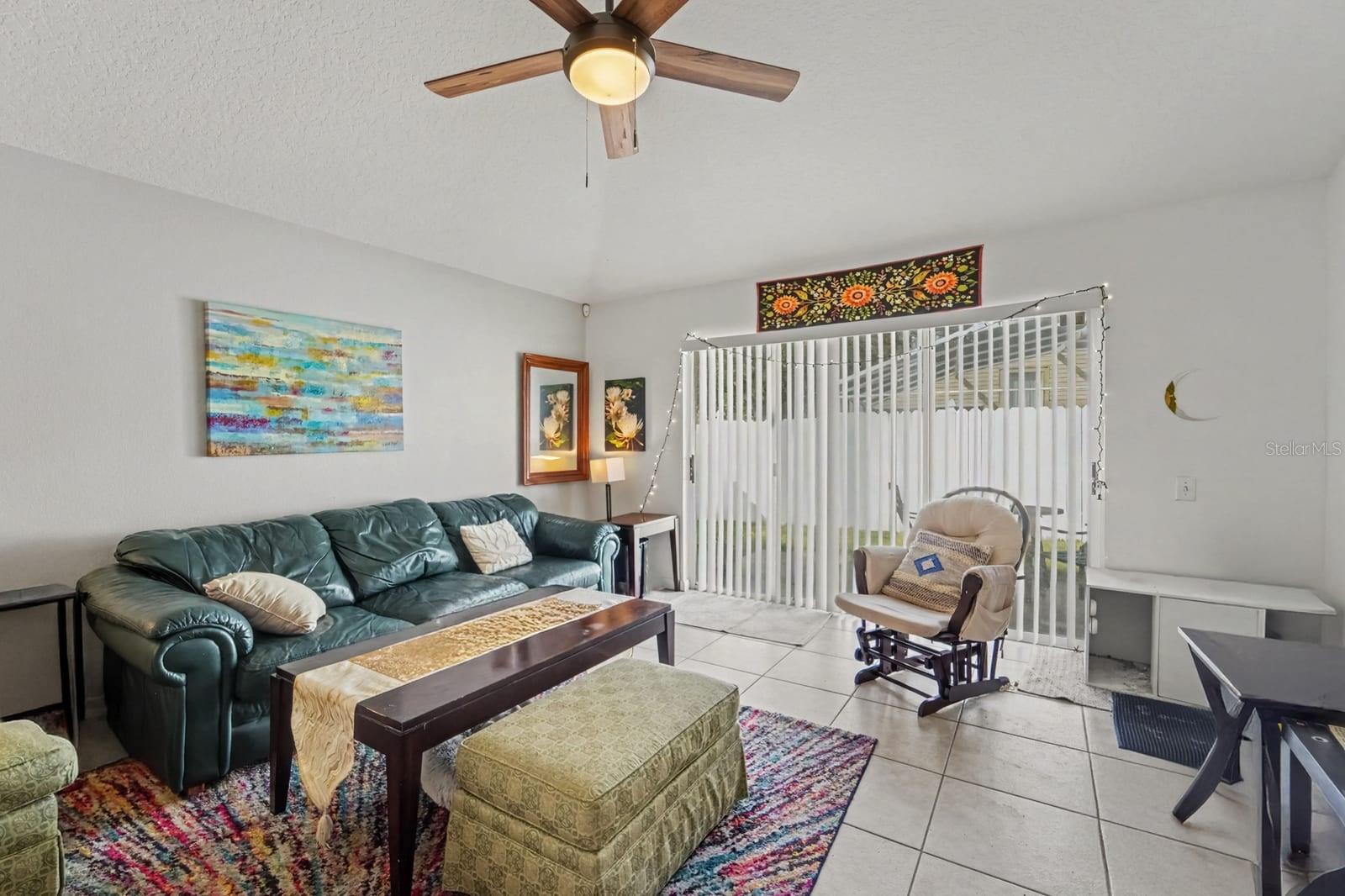 Open-concept living space with tile flooring and direct access to outdoor area Open-concept living space with tile flooring and direct access to outdoor area