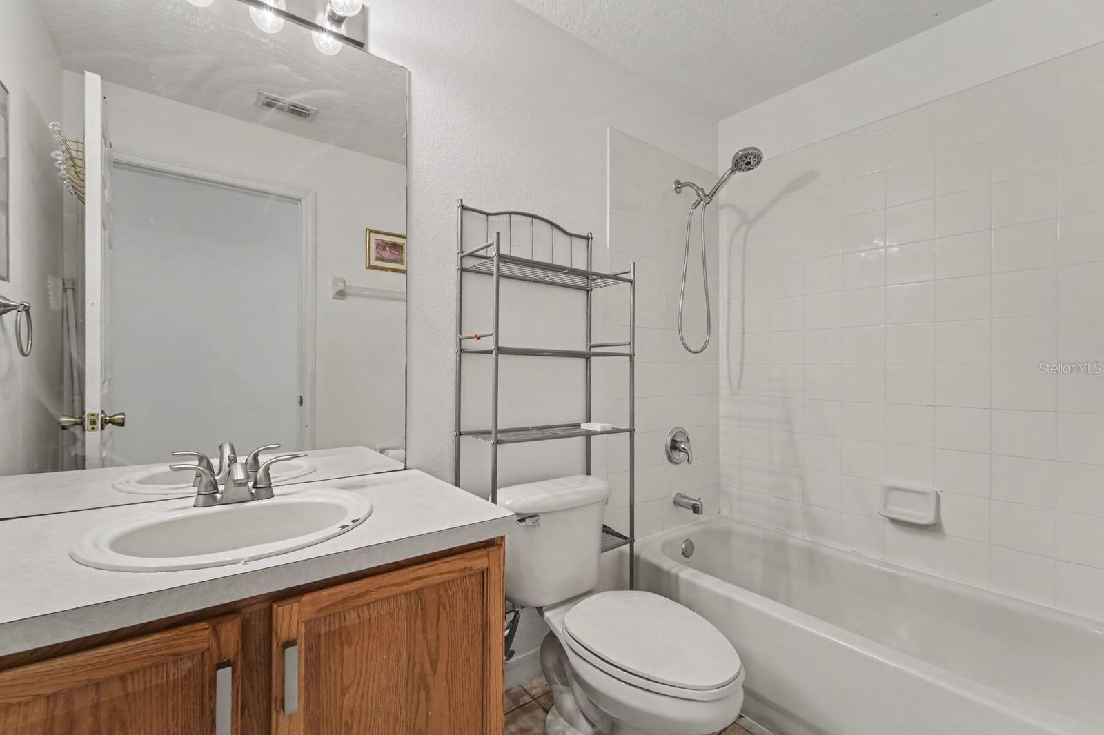 Luxurious Master Bath with Dual Vanity, Garden Tub, Separate Shower, and Decorative Details